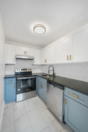 a kitchen with granite countertop a sink and cabinets
