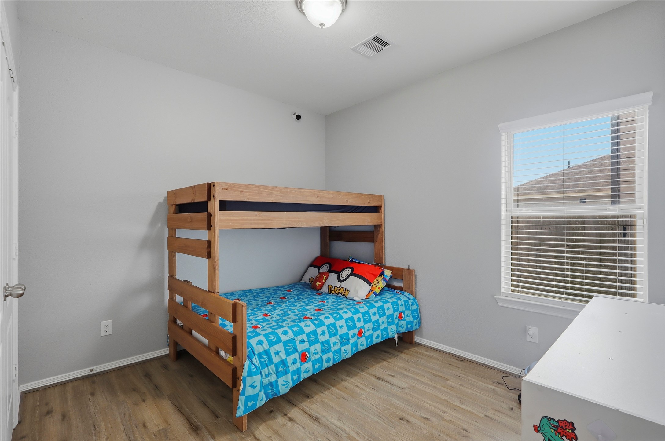 9938 Yanet Grove Lane Houston, TX 77044 - Photo 13 of 21 a bedroom with a bed and a window