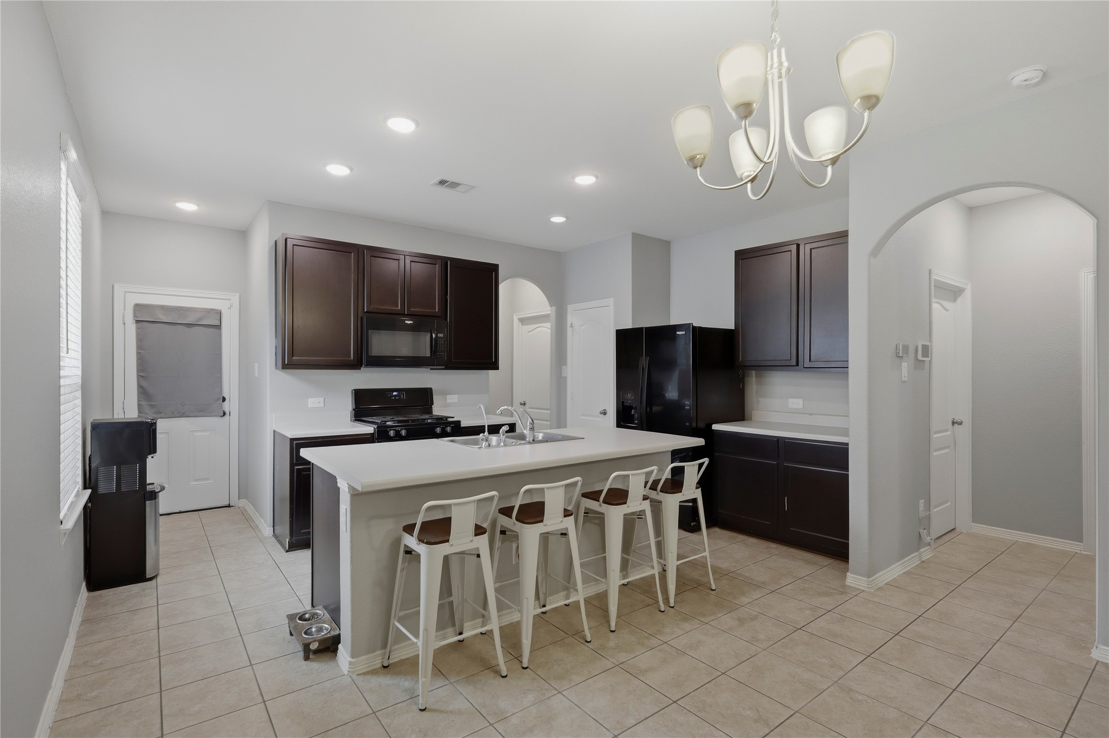9938 Yanet Grove Lane Houston, TX 77044 - Photo 5 of 21 a view of kitchen with cabinets stainless steel appliances and a counter top space