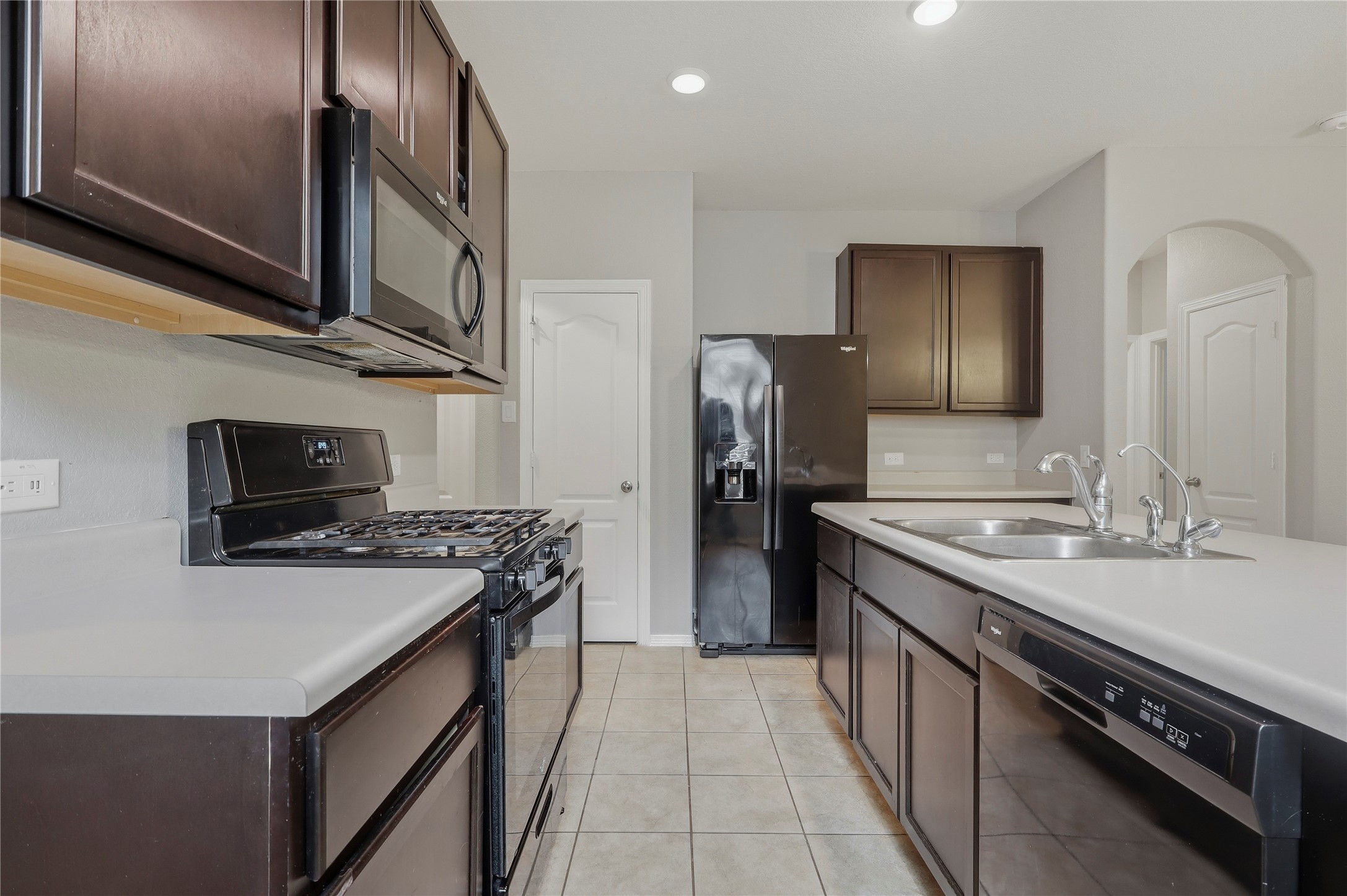 9938 Yanet Grove Lane Houston, TX 77044 - Photo 8 of 21 a kitchen with stainless steel appliances a sink stove and refrigerator