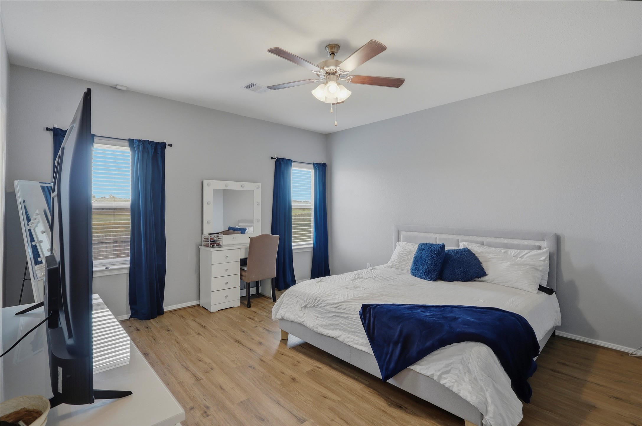 9938 Yanet Grove Lane Houston, TX 77044 - Photo 9 of 21 a bedroom with a bed and a large mirror with a dresser