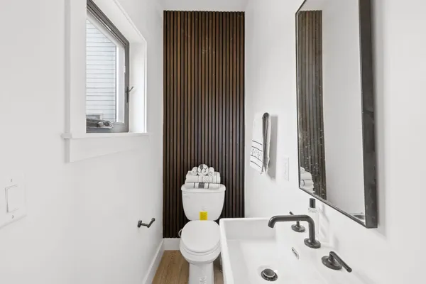 a bathroom with a toilet sink and mirror