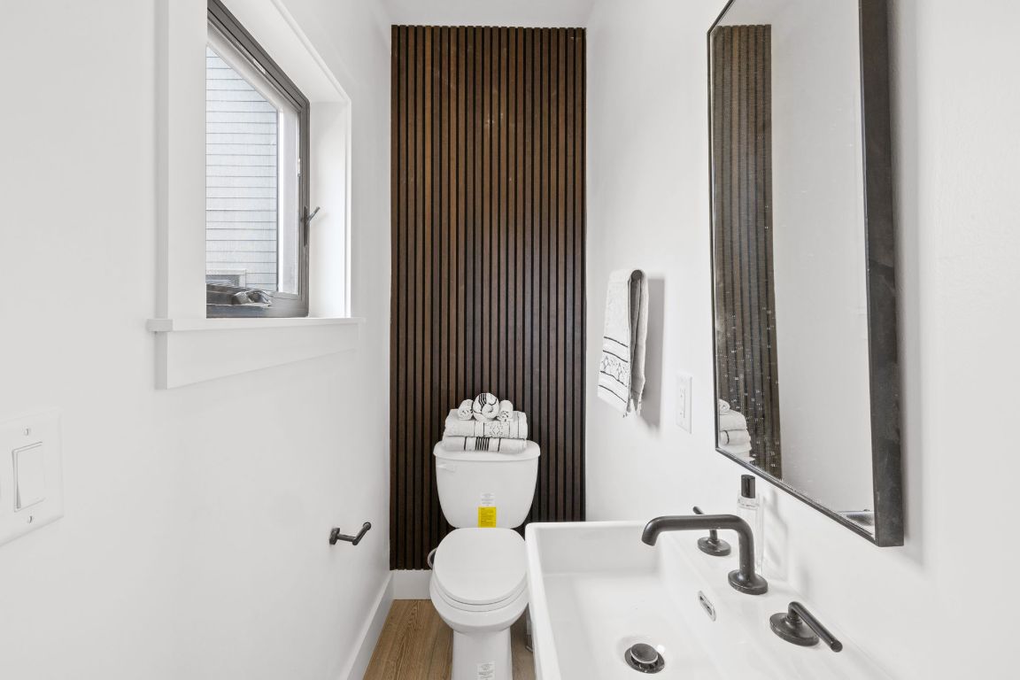 4710 Clarkson Avenue Austin, TX 78751 - Photo 12 of 14 a bathroom with a toilet sink and mirror