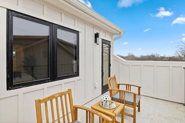a view of a balcony with furniture and city view