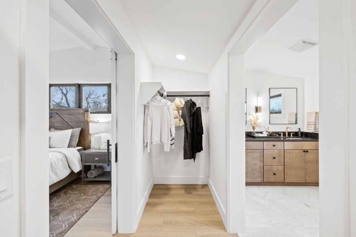 4710 Clarkson Avenue Austin, TX 78751 - Photo 6 of 14 a en suite bathroom with a granite countertop sink and a mirror