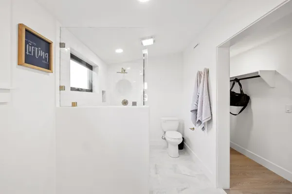 a bathroom with a shower a toilet and a sink