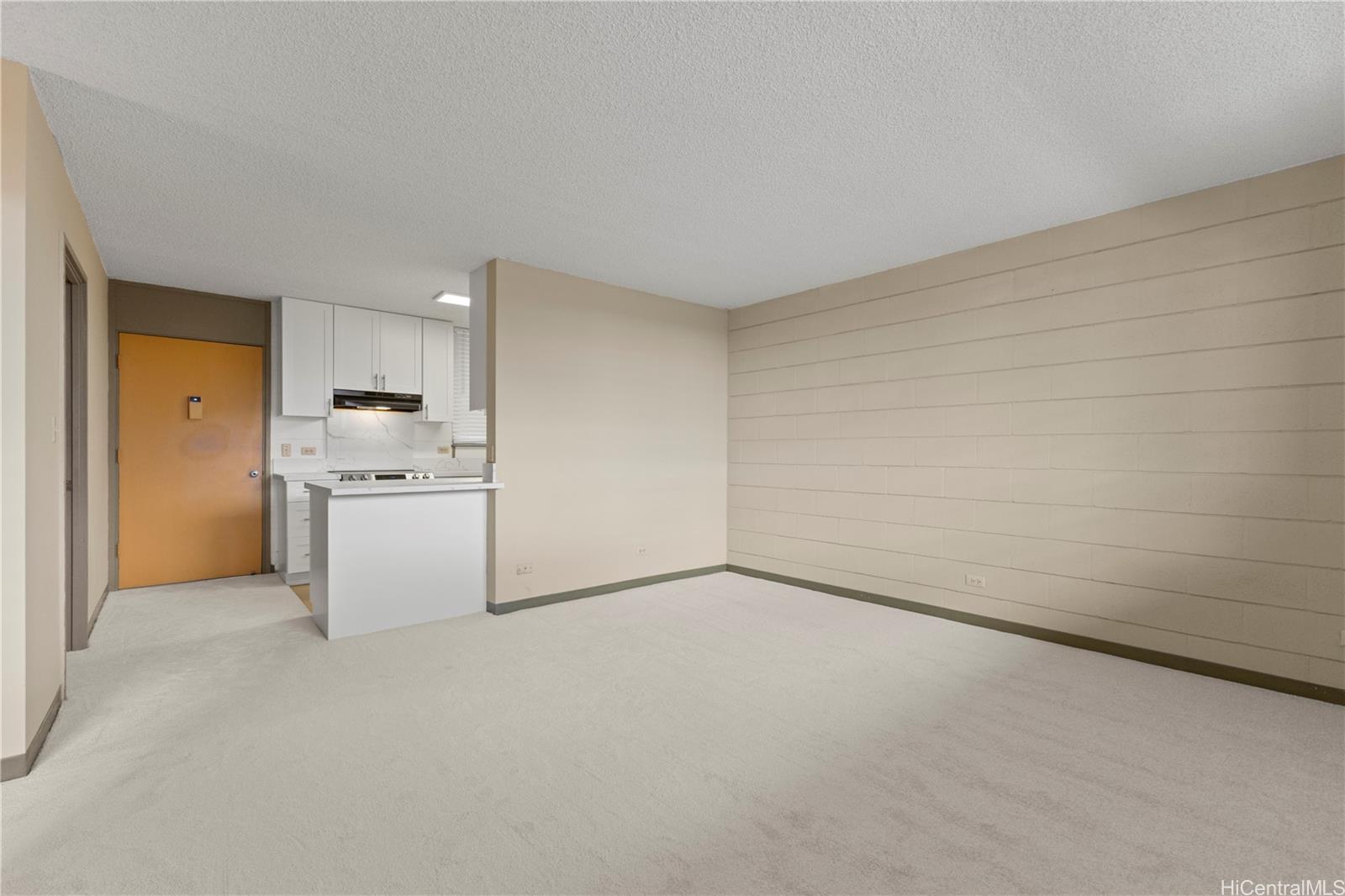 633 Nalanui Street, Unit 409 Honolulu, HI 96817 - Photo 2 of 15 a view of a kitchen with white cabinets