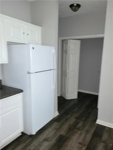 a white refrigerator freezer sitting in a kitchen