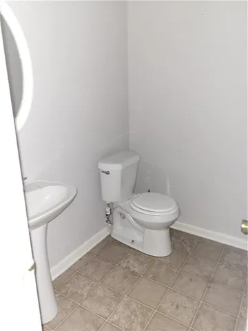 a white toilet sitting next to a shower