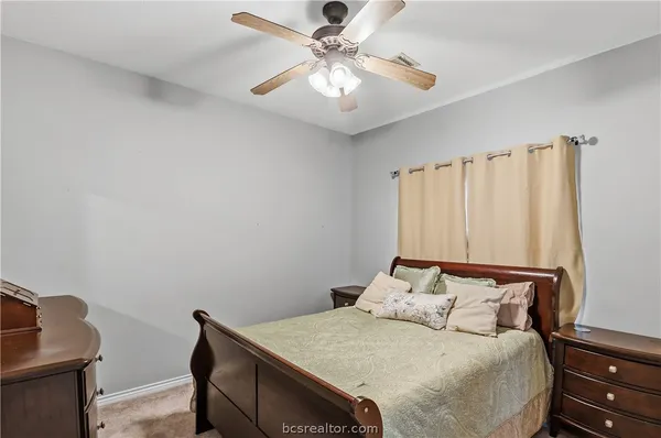 a bed sitting in a bedroom next to a window