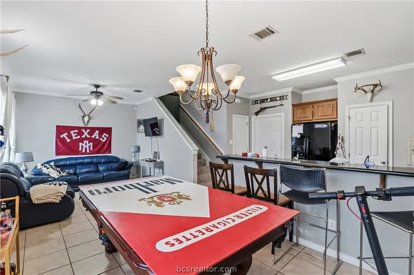 a living room with furniture and a chandelier