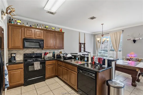 a kitchen with a sink stove and cabinets