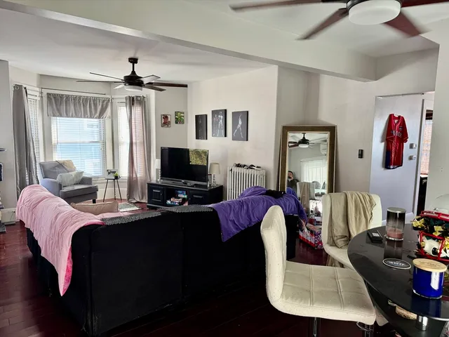 a living room with furniture fireplace and a window
