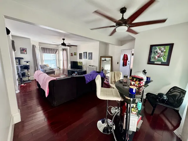 a bedroom with furniture and a large window