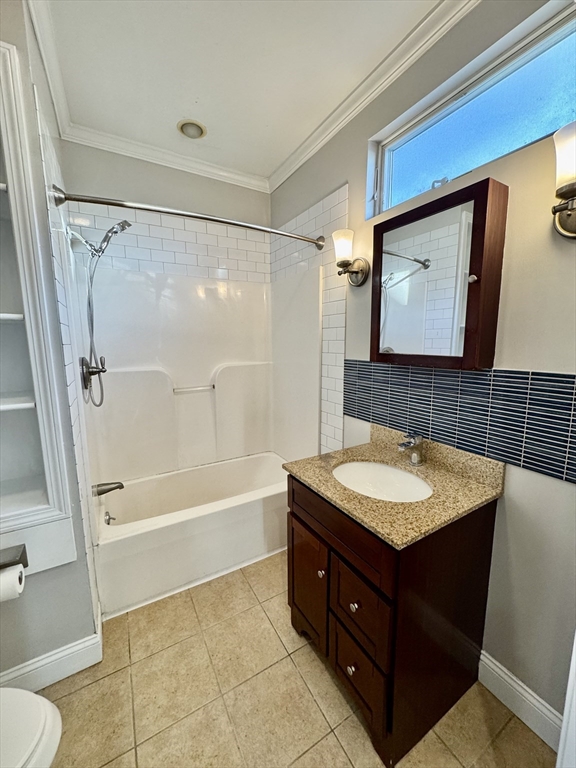 6 Gould Street, Unit 2 Stoneham, MA 02180 - Photo 13 of 27 a bathroom with a sink a toilet a mirror and bathtub