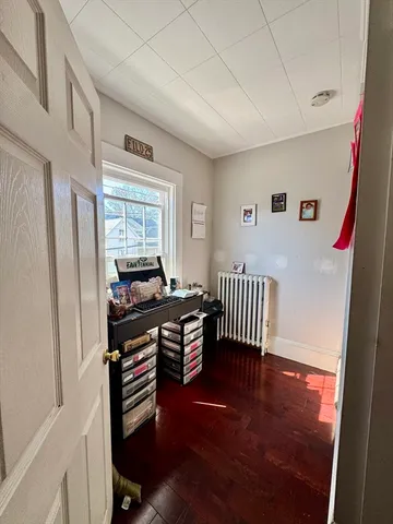 a bedroom with furniture and wooden floor
