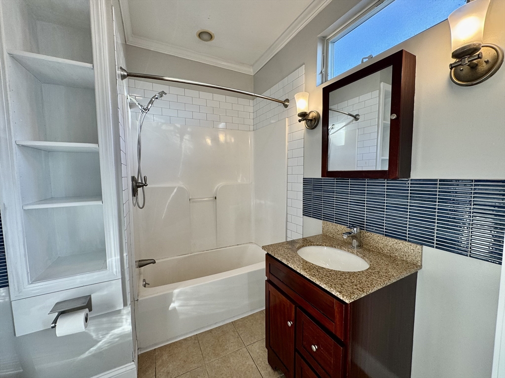 6 Gould Street, Unit 2 Stoneham, MA 02180 - Photo 16 of 27 a bathroom with a sink and a mirror