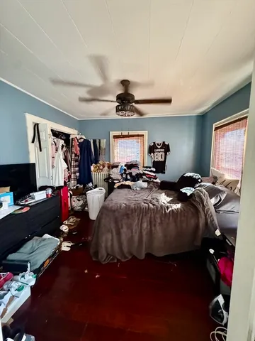 a bed room with a bed mirror and a window