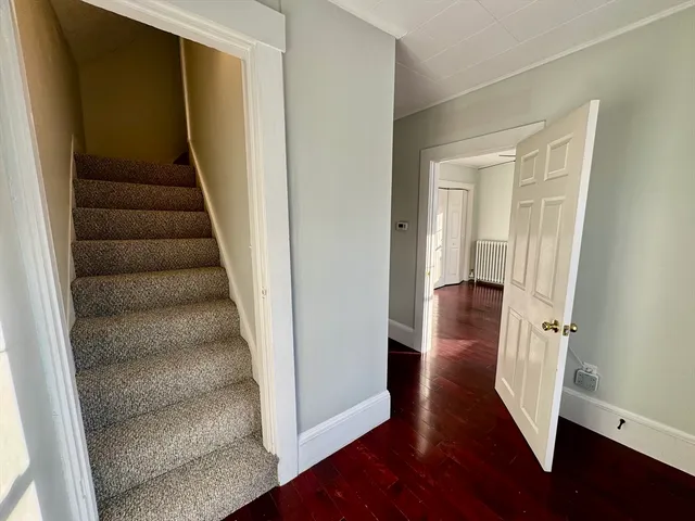 wooden view of entryway with wooden floor and stairs