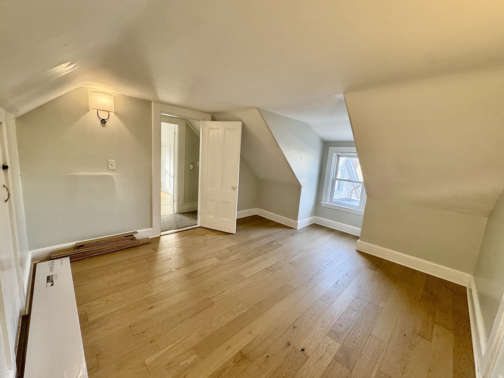 6 Gould Street, Unit 2 Stoneham, MA 02180 - Photo 22 of 27 an empty room with wooden floor and windows