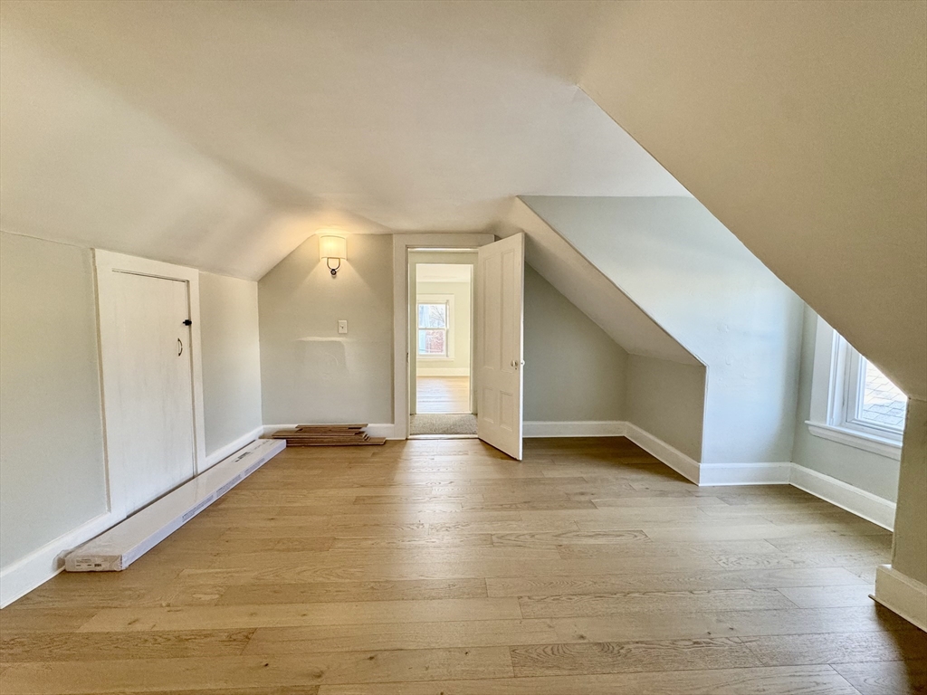 6 Gould Street, Unit 2 Stoneham, MA 02180 - Photo 23 of 27 a view of an empty room with window and wooden floor