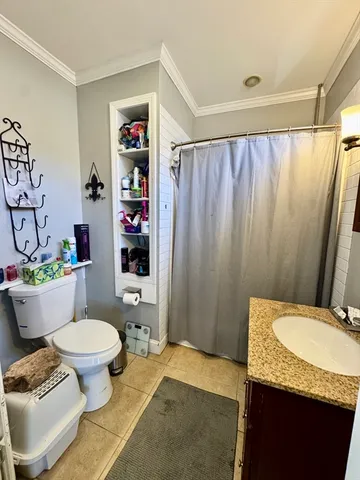 a bathroom with a granite countertop toilet sink and shower