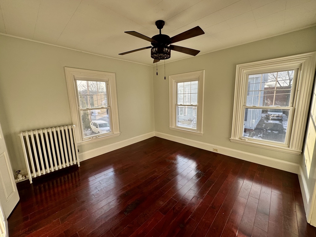 6 Gould Street, Unit 2 Stoneham, MA 02180 - Photo 10 of 27 a view of an empty room with wooden floor and a window
