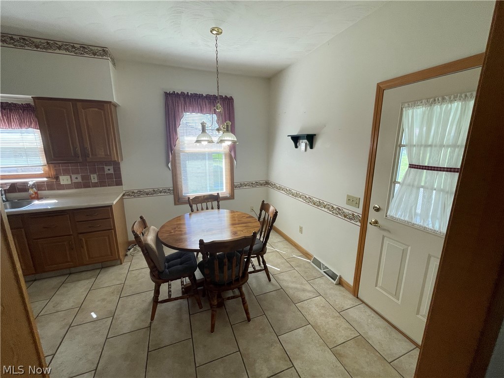 185 Mathews Road Youngstown, OH 44512 - Photo 9 of 29 Dining area featuring a healthy amount of sunlight and light tile floors