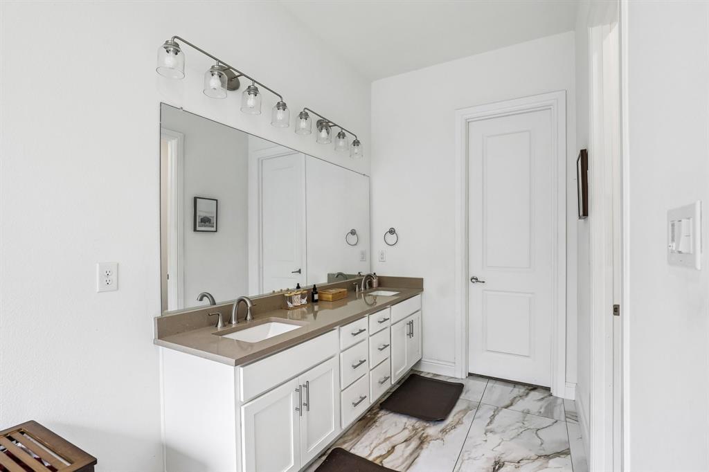 515 West Laureland Road Dallas, TX 75232 - Photo 22 of 32 a spacious bathroom with a sink and a mirror
