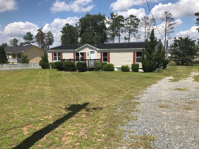12 Whitening Road Butler, GA 31006 - Photo 1 of 12 a front view of house with yard along with trees