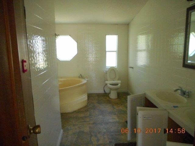 12 Whitening Road Butler, GA 31006 - Photo 10 of 12 a bathroom with a toilet a sink and mirror