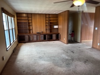 8707 Huber Road Belvidere, IL 61008 - Photo 5 of 13 an empty room with windows and a chandelier fan