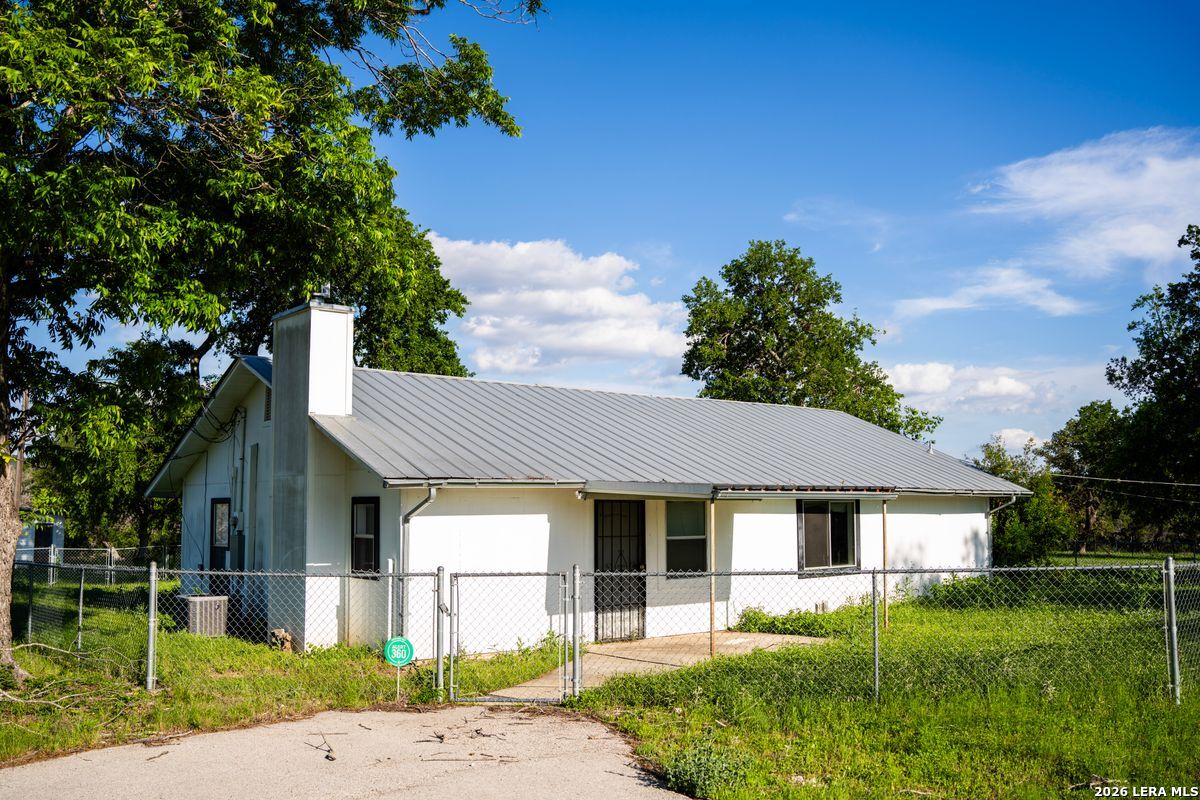 3584 Privilege Creek Road Pipe Creek, TX 78063 - Photo 22 of 44 a front view of a house with a yard