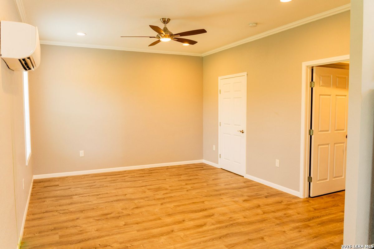 3584 Privilege Creek Road Pipe Creek, TX 78063 - Photo 29 of 44 a view of a big room with wooden floor and a ceiling fan