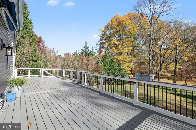 a view of a balcony with wooden floor and fence