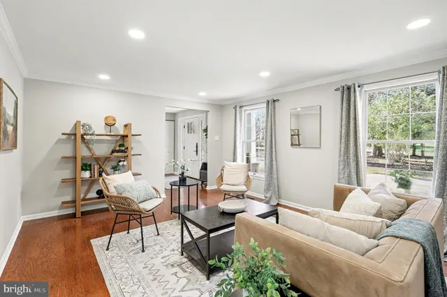 a bathroom with a granite countertop sink a toilet a mirror and window