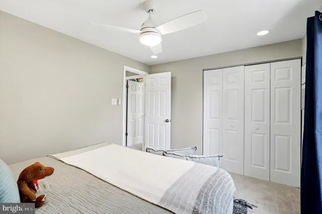 a bed room with a bed a rug and a window