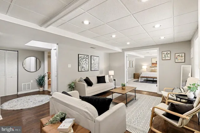 a view of a room with furniture and floor to ceiling windows