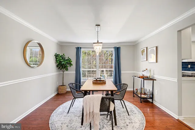 a dining room with furniture window and wooden floor