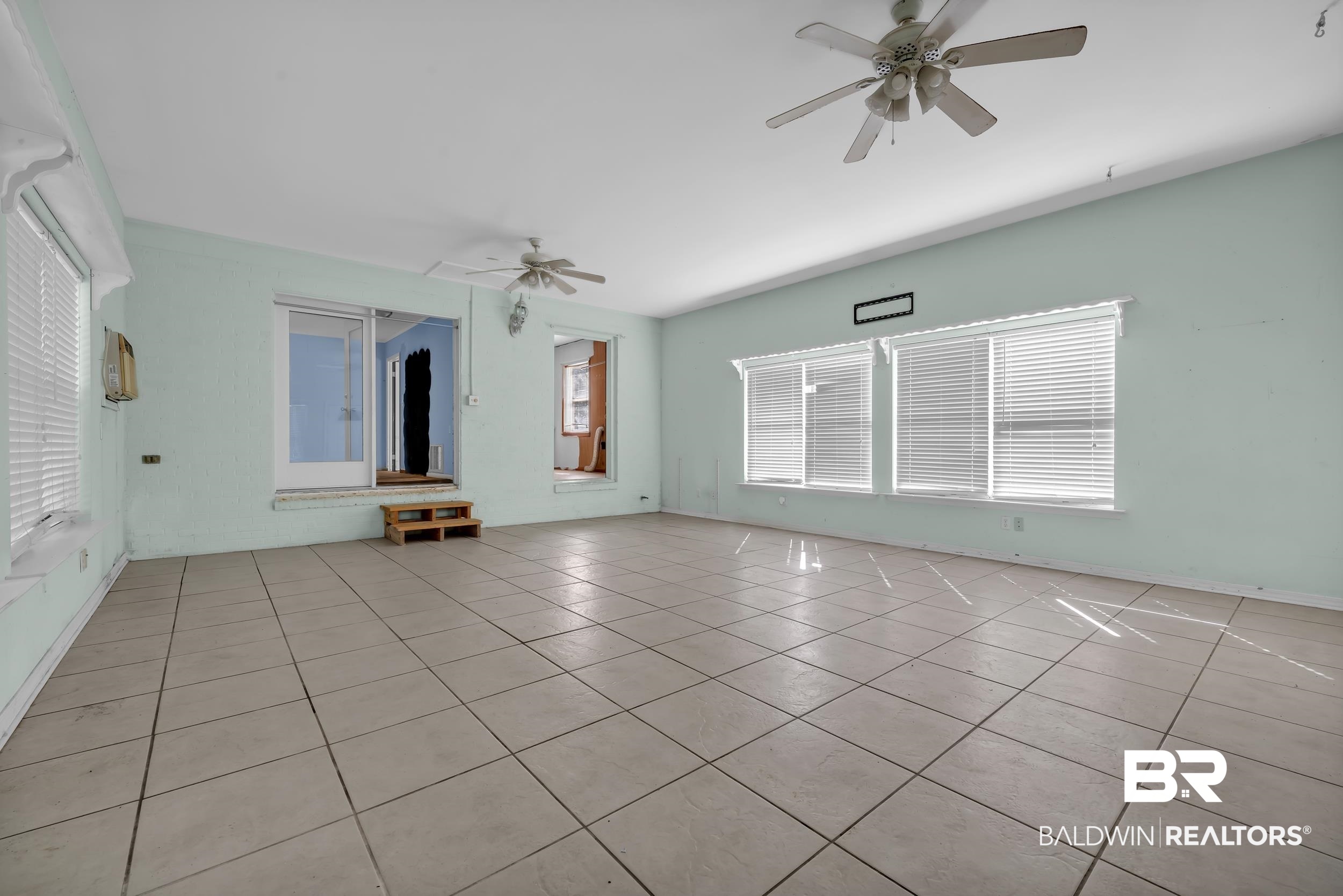 17463 Highway 98 Foley, AL 36535 - Photo 12 of 57 Unfurnished room with light tile patterned floors, a ceiling fan, and plenty of natural light
