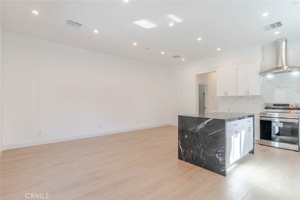 6852 Ranchito Avenue Van Nuys, CA 91405 - Photo 3 of 18 a kitchen with stainless steel appliances granite countertop a stove a sink and a refrigerator