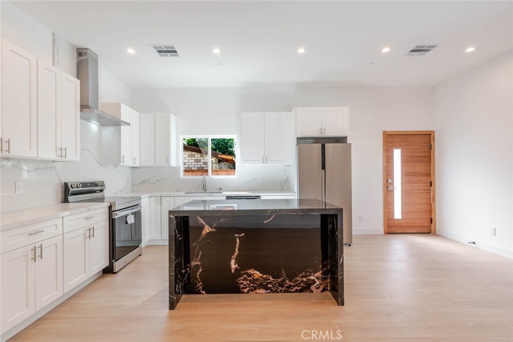 6852 Ranchito Avenue Van Nuys, CA 91405 - Photo 8 of 18 a kitchen with stainless steel appliances granite countertop a sink stove and refrigerator