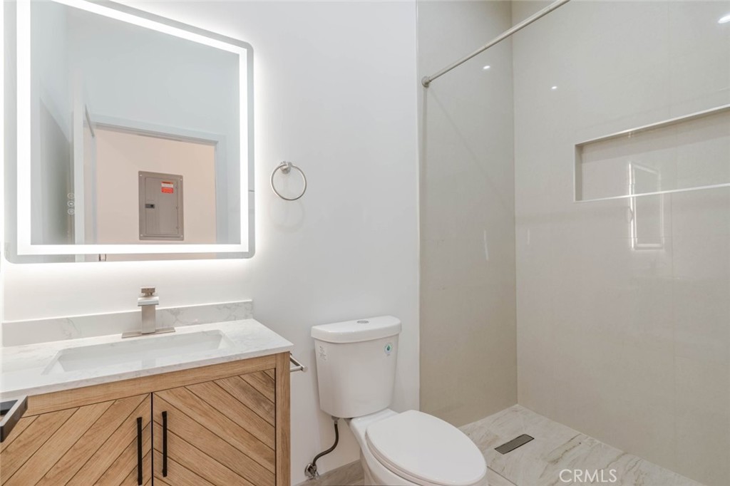 6852 Ranchito Avenue Van Nuys, CA 91405 - Photo 10 of 18 a bathroom with a toilet a sink and mirror