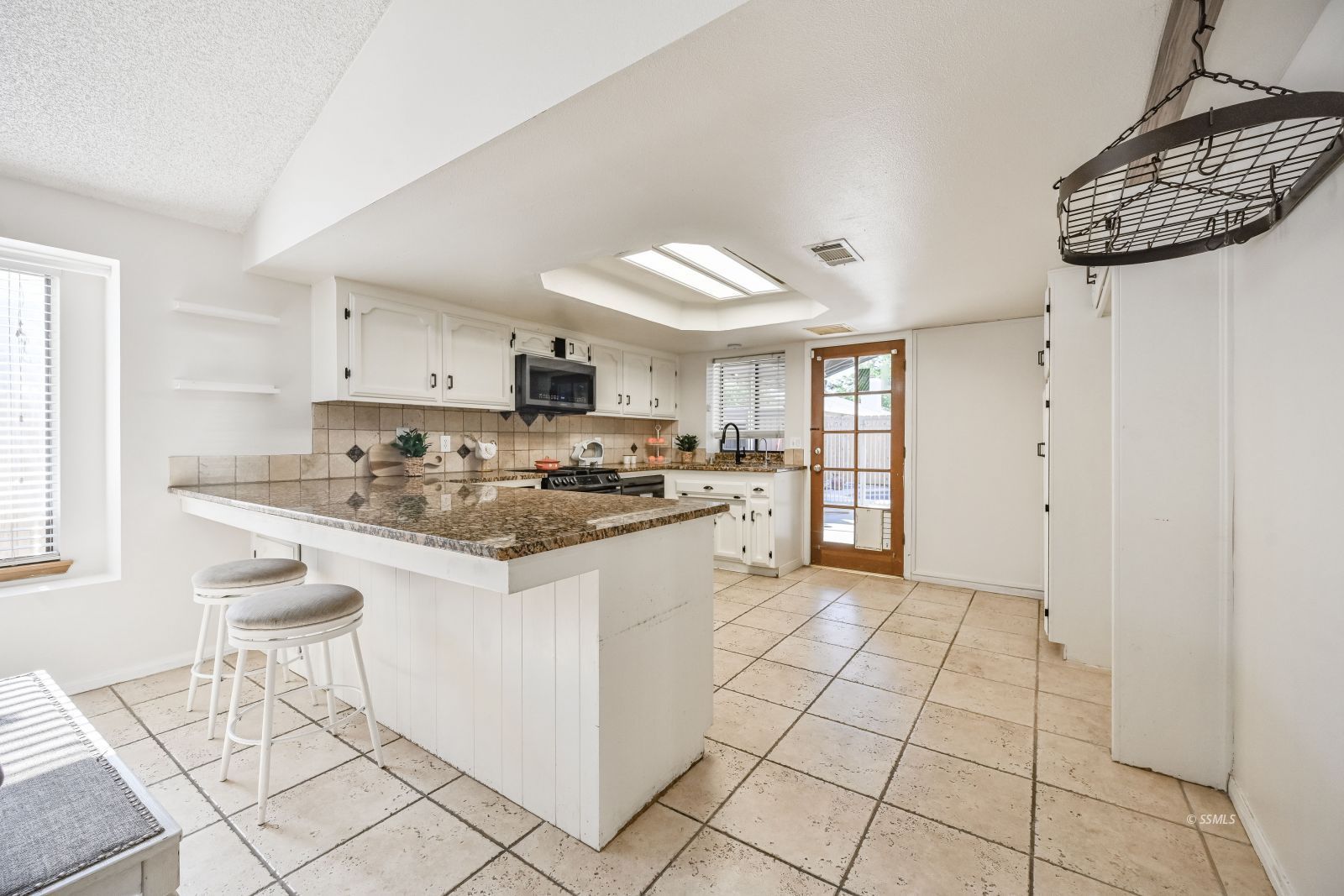 815 Walker Lane Ridgecrest, CA 93555 - Photo 5 of 23 a kitchen with granite countertop a sink cabinets and window