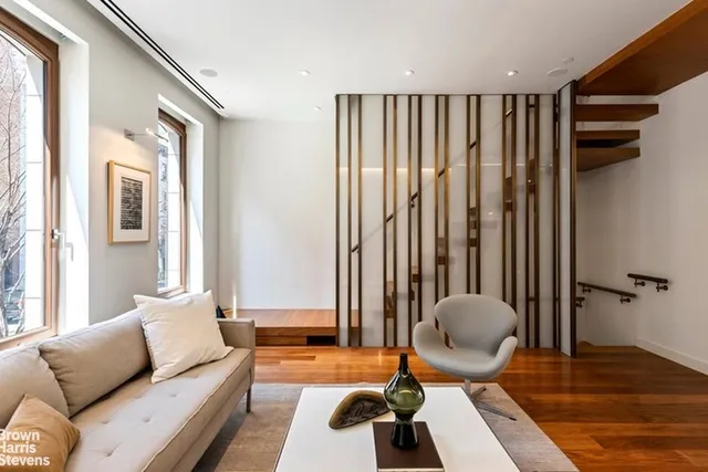 a living room with furniture and wooden floor