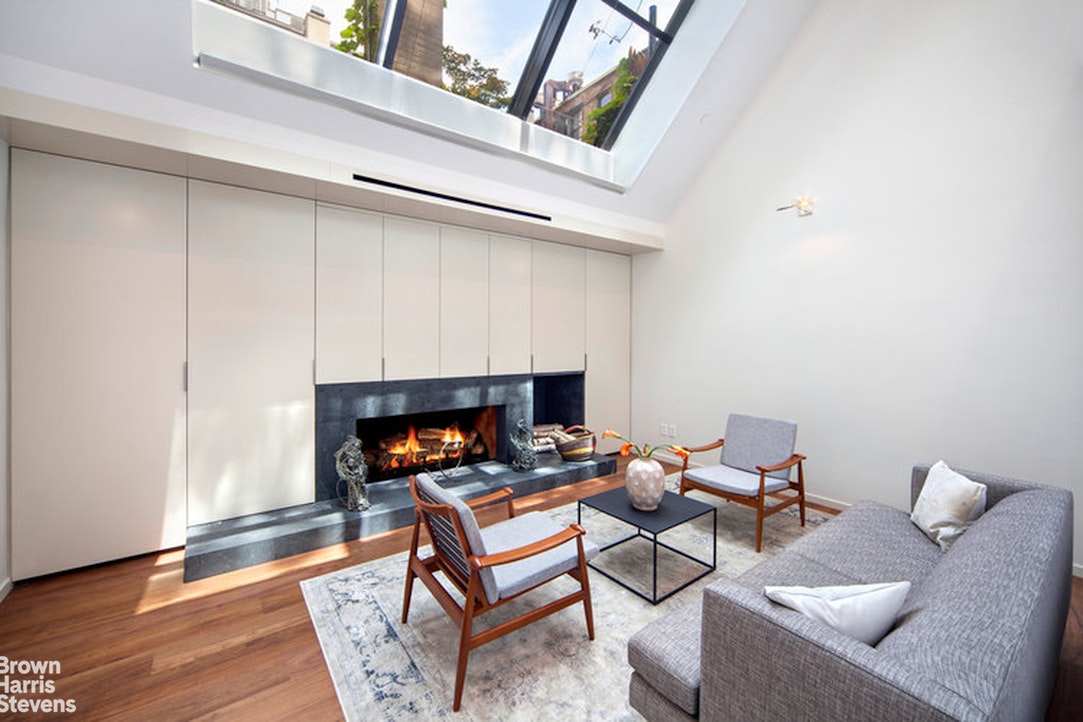 251 East 61st Street Manhattan, NY 10065 - Photo 21 of 39 a reading room with furniture and a fireplace
