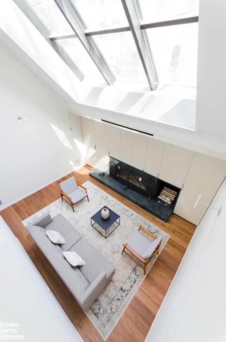 251 East 61st Street Manhattan, NY 10065 - Photo 22 of 39 a view of a living room with furniture and a window