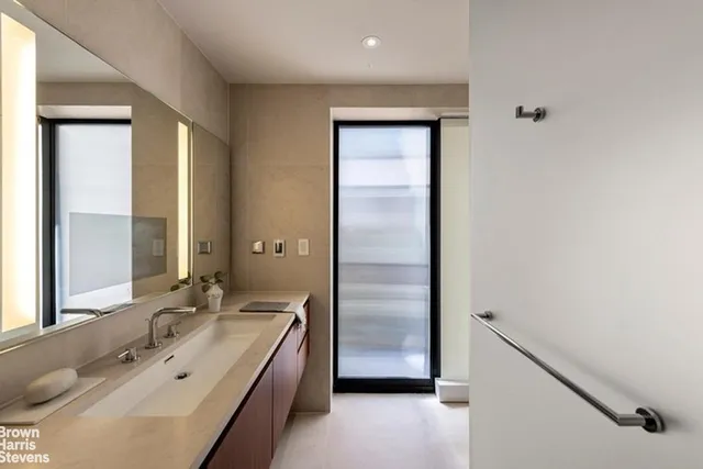 a spacious bathroom with a double vanity sink and a mirror