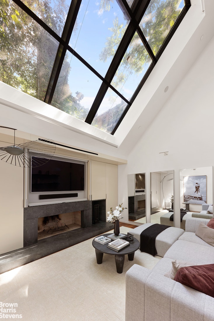 251 East 61st Street Manhattan, NY 10065 - Photo 33 of 39 a living room with furniture and a flat screen tv