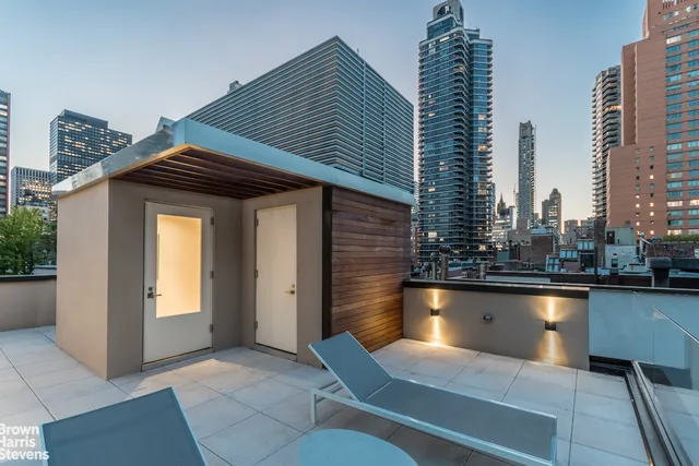 a view of a swimming pool with outdoor seating